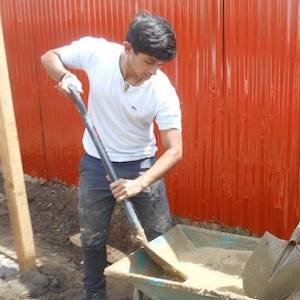 volunteer laying concrete floor